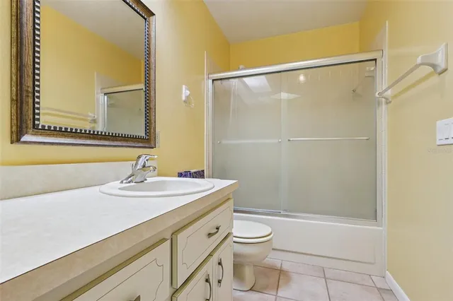 a bathroom with a sink mirror vanity and toilet