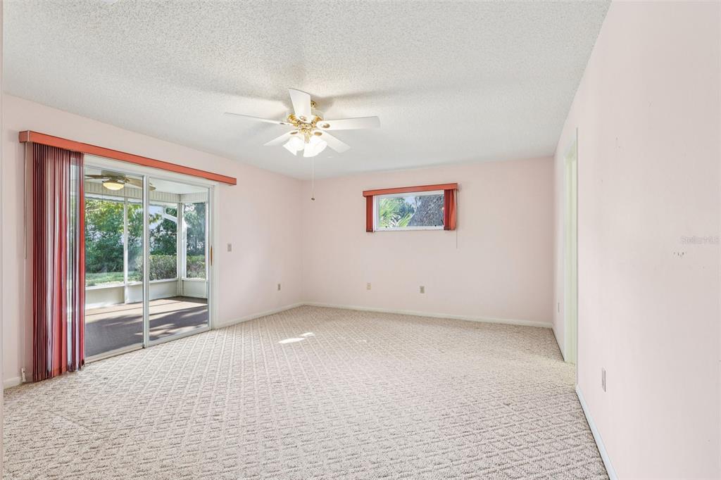 305 Brigadoon Circle Leesburg, FL 34788 - Photo 25 of 38 en empty room with windows and ceiling fan