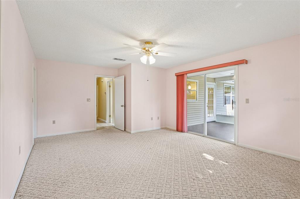 305 Brigadoon Circle Leesburg, FL 34788 - Photo 27 of 38 an empty room with a ceiling fan and a window