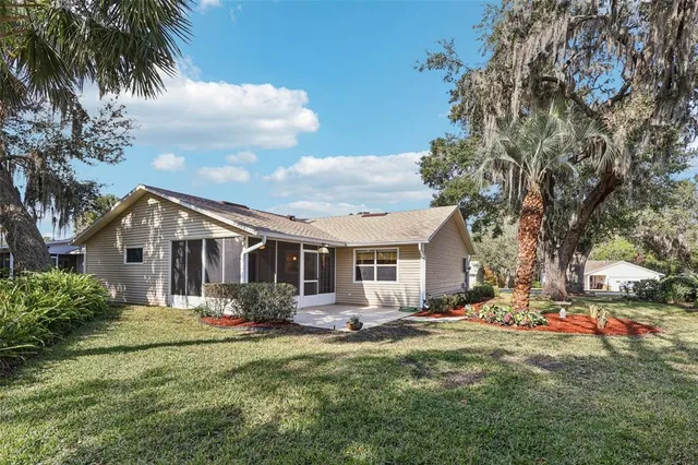 a front view of house with yard and trees around
