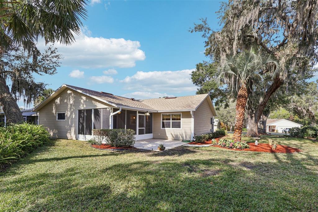 305 Brigadoon Circle Leesburg, FL 34788 - Photo 35 of 38 a front view of house with yard and trees around