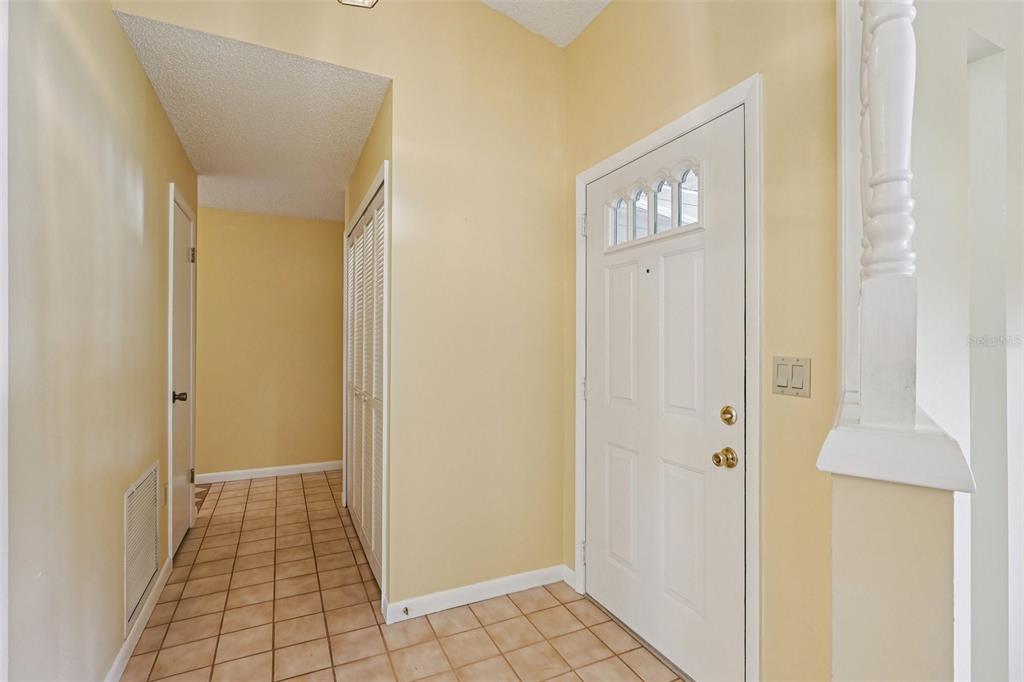 305 Brigadoon Circle Leesburg, FL 34788 - Photo 6 of 38 a view of a hallway with wooden floor and cabinet