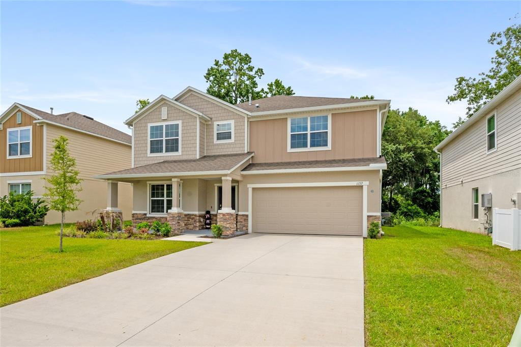 1137 Bradford Rdg Drive Leesburg, FL 34748 - Photo 1 of 37 a front view of house with yard and green space