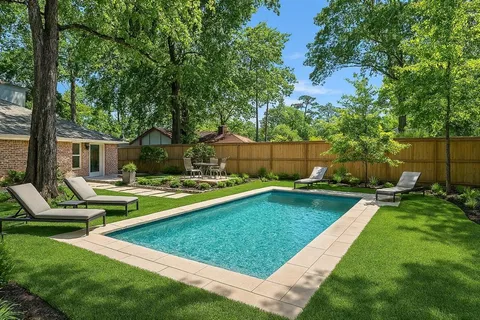 a view of a house with swimming pool and sitting area