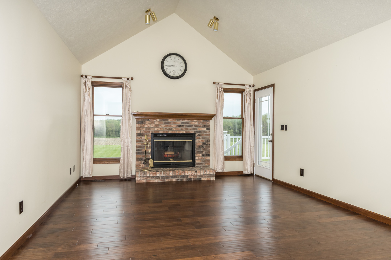 9375 East 3000 N Road Cornell, IL 61319 - Photo 11 of 39 an empty room with wooden floor and a fireplace