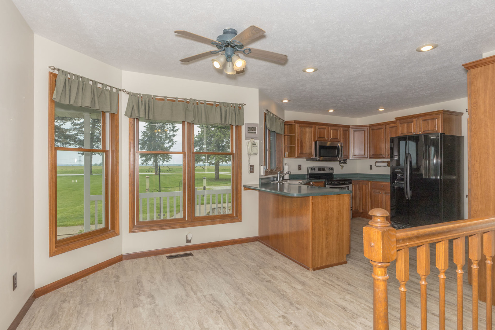 9375 East 3000 N Road Cornell, IL 61319 - Photo 14 of 39 a open kitchen with stainless steel appliances granite countertop a refrigerator a sink a stove and oven with wooden floor