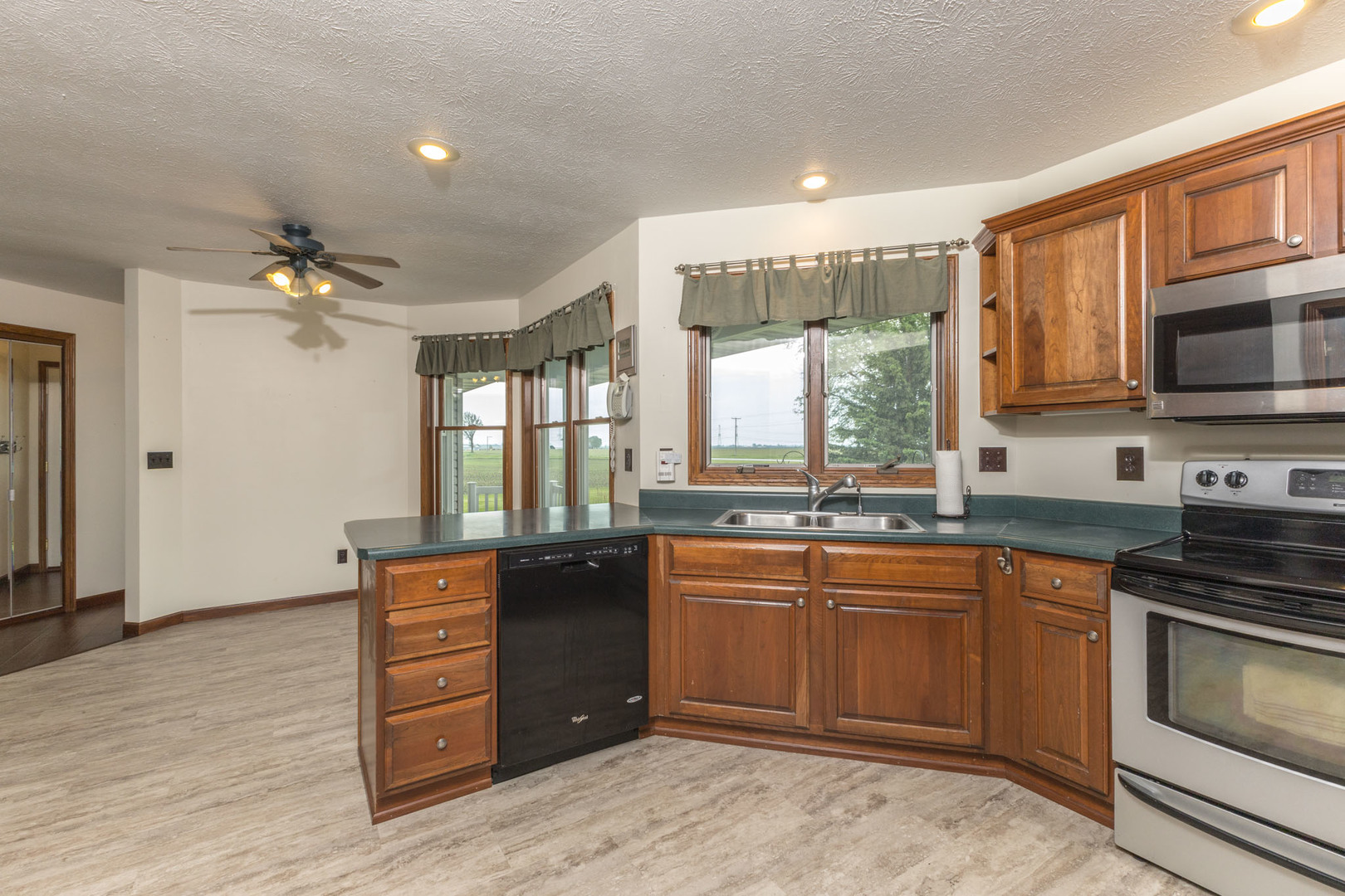 9375 East 3000 N Road Cornell, IL 61319 - Photo 17 of 39 a kitchen with stainless steel appliances granite countertop a sink and cabinets