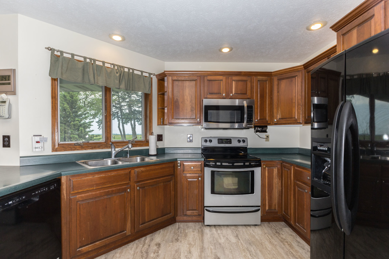 9375 East 3000 N Road Cornell, IL 61319 - Photo 18 of 39 a kitchen with a sink stove and refrigerator