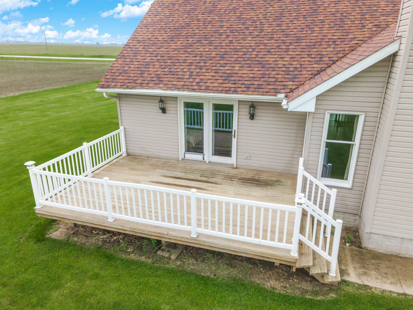 9375 East 3000 N Road Cornell, IL 61319 - Photo 29 of 39 a porch with a bench next to a yard
