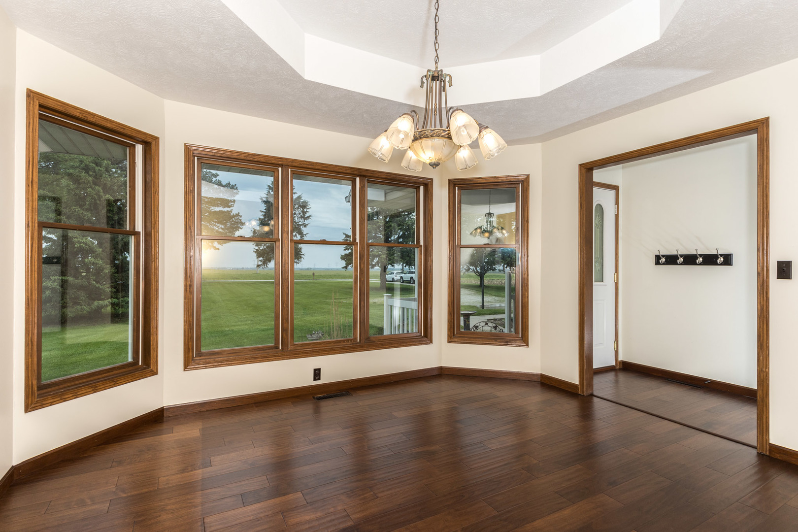 9375 East 3000 N Road Cornell, IL 61319 - Photo 5 of 39 a view of a livingroom with furniture wooden floor front door and windows