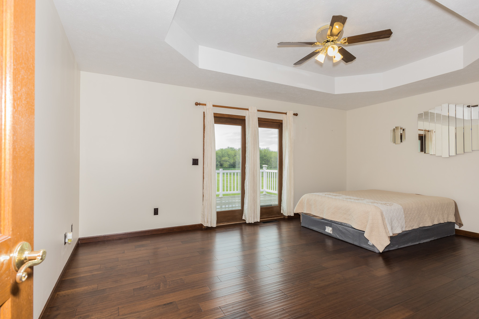 9375 East 3000 N Road Cornell, IL 61319 - Photo 6 of 39 a spacious bedroom with a bed and a chandelier
