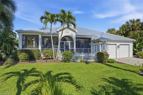 a living room with furniture a flat screen tv and a large window