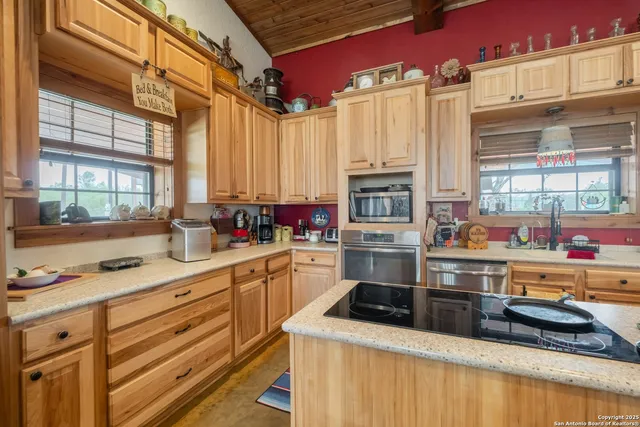 a kitchen with stainless steel appliances a stove sink and cabinets
