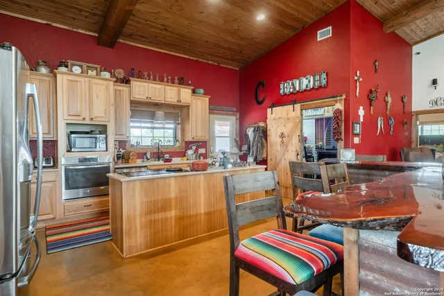 a kitchen with table and chairs