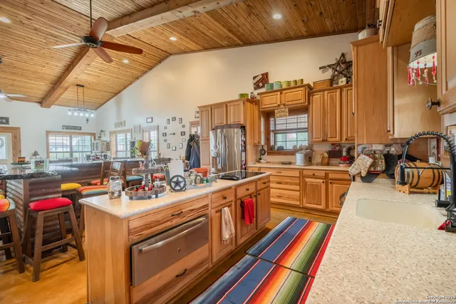 a view of a kitchen with appliances and furniture