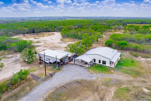 an aerial view of a house with garden space and street view