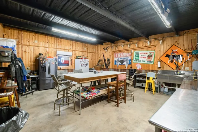a outdoor space with lots of tables a large window and chairs
