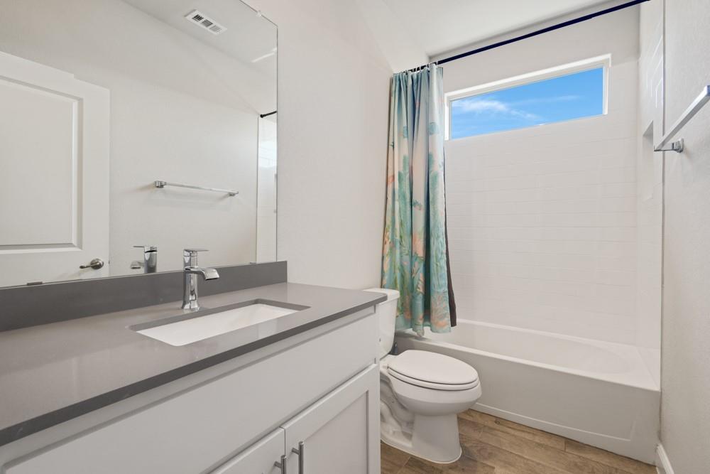 1112 Croxley Way Justin, TX 76247 - Photo 11 of 18 Modern vanity featuring a gray countertop with an integrated rectangular sink and chrome faucet