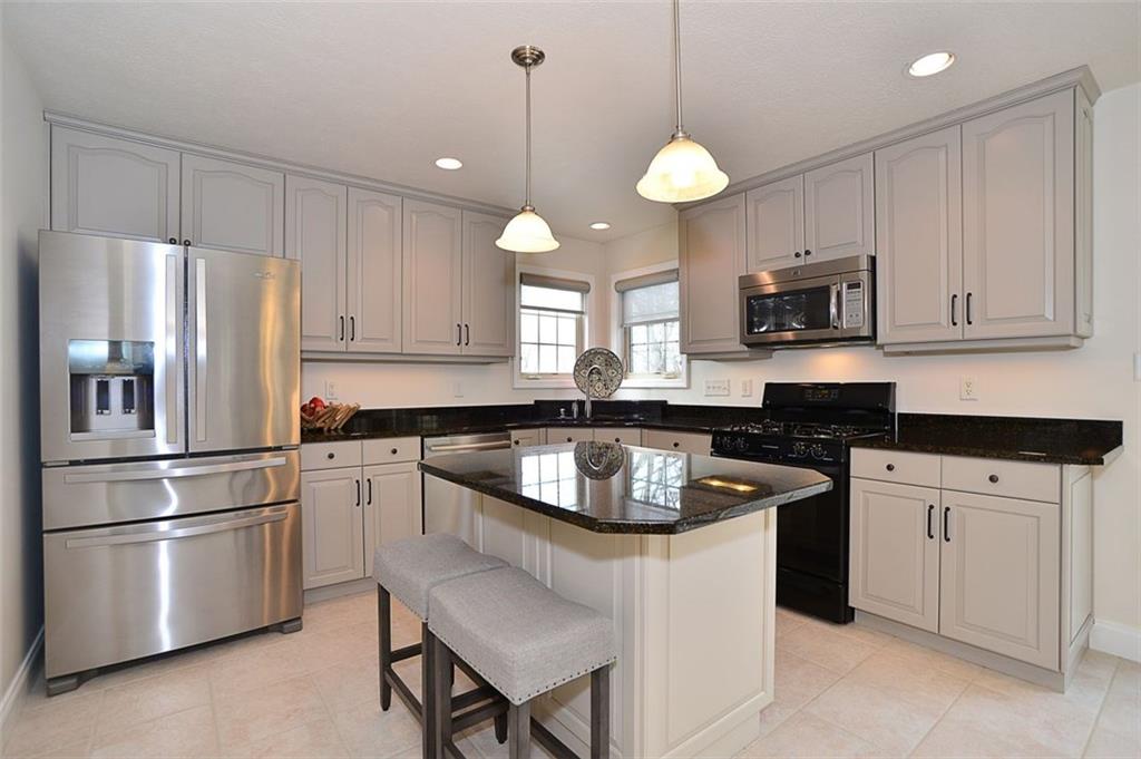 173 Warren Road Warrendale, PA 15086 - Photo 11 of 25 Kitchen enjoys island with seating for that morning coffee or a quick sandwich, updated cabinets and dual windows that capture the great outdoors.