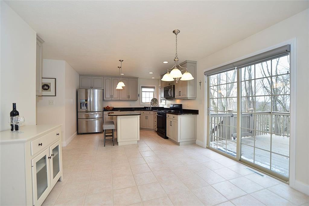173 Warren Road Warrendale, PA 15086 - Photo 9 of 25 Updated kitchen features spacious Eat-In area with a glass sliding door, with custom shades, that opens the Upper Deck area for an EXPANDED living area. The Upper Deck also features a power SunSetter awning.