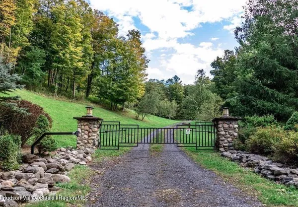 a view of a yard with flower plants and wooden fence