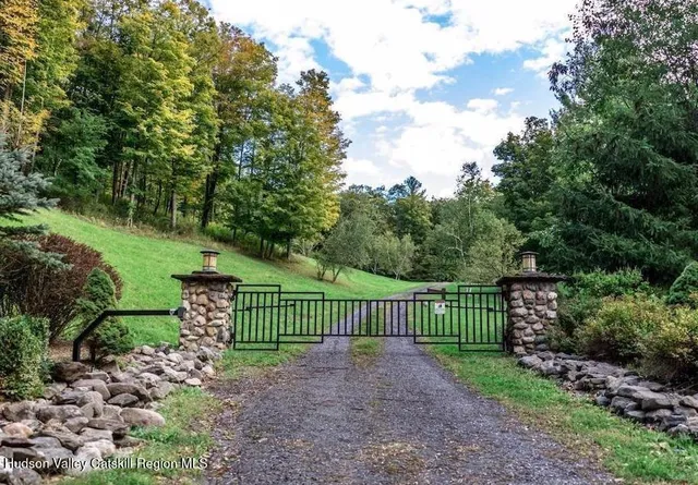 a view of a yard with flower plants and wooden fence