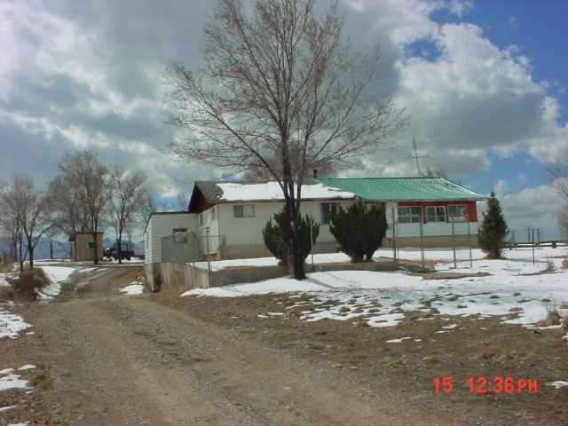 25716 Rd L Cortez, CO 81321 - Photo 1 of 4 a street view with large trees