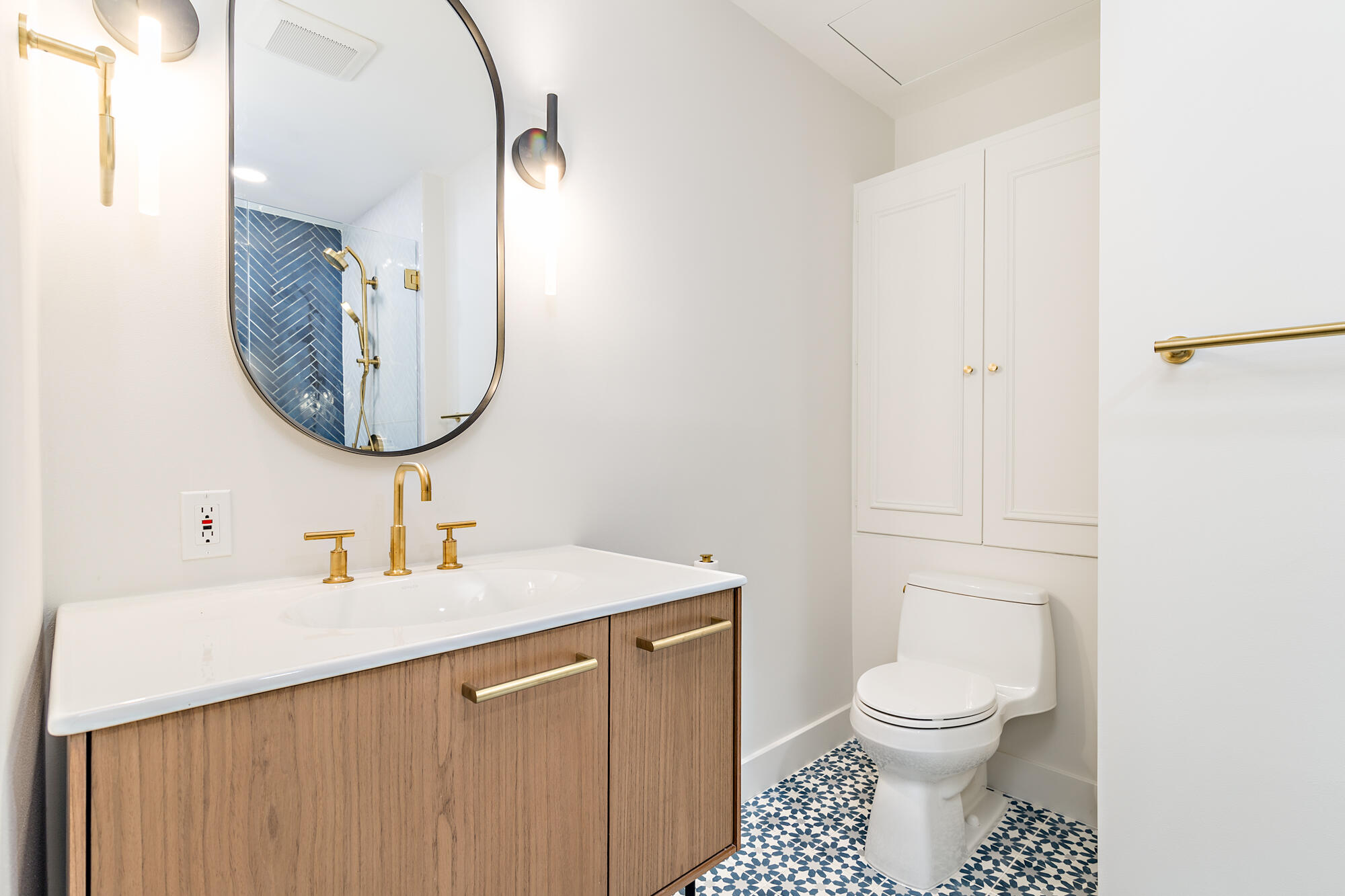 239 Emerald Lane Palm Beach, FL 33480 - Photo 9 of 29 a bathroom with a toilet sink and mirror