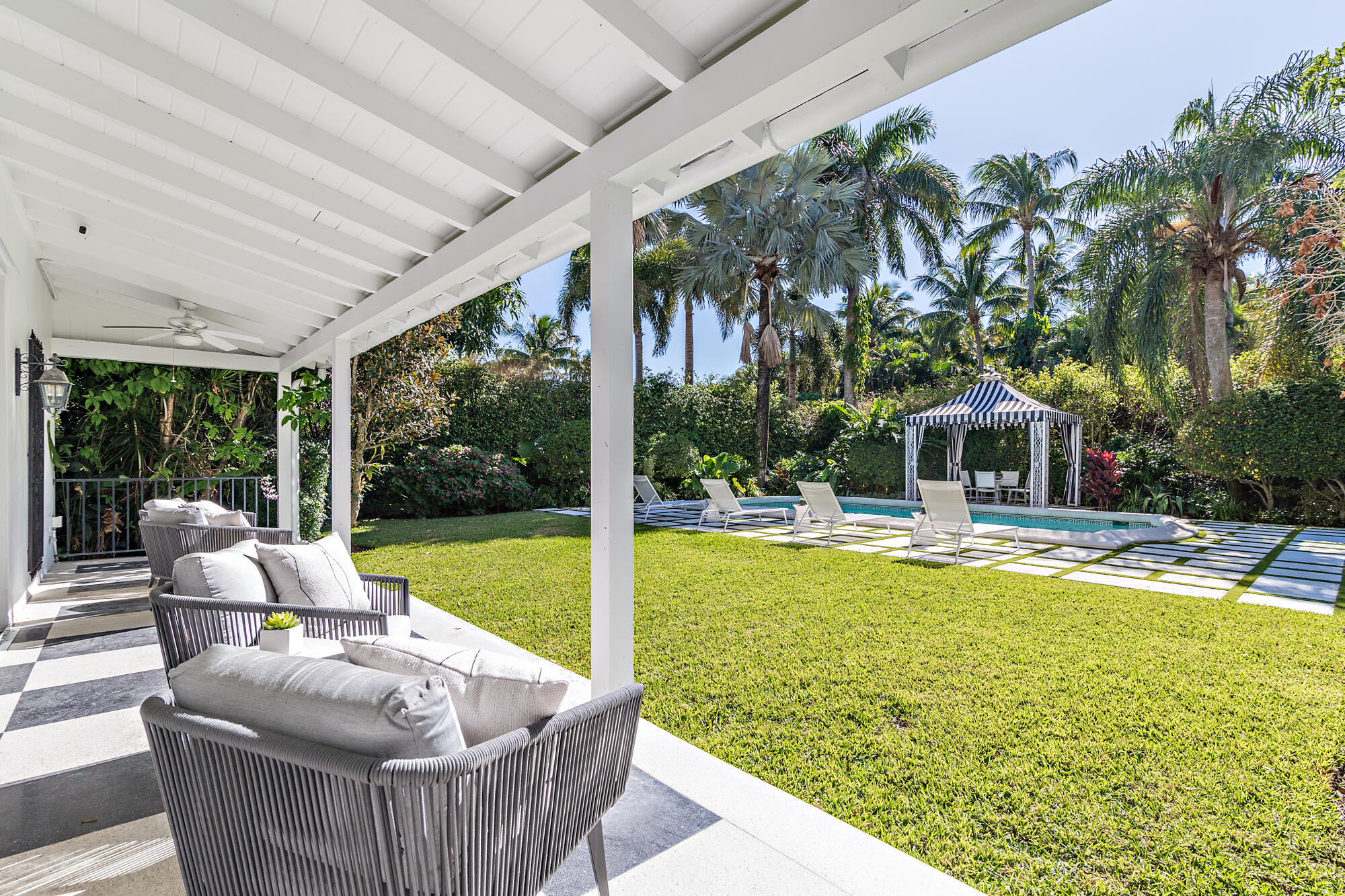 239 Emerald Lane Palm Beach, FL 33480 - Photo 11 of 29 a view of swimming pool with lawn chairs and a large tree