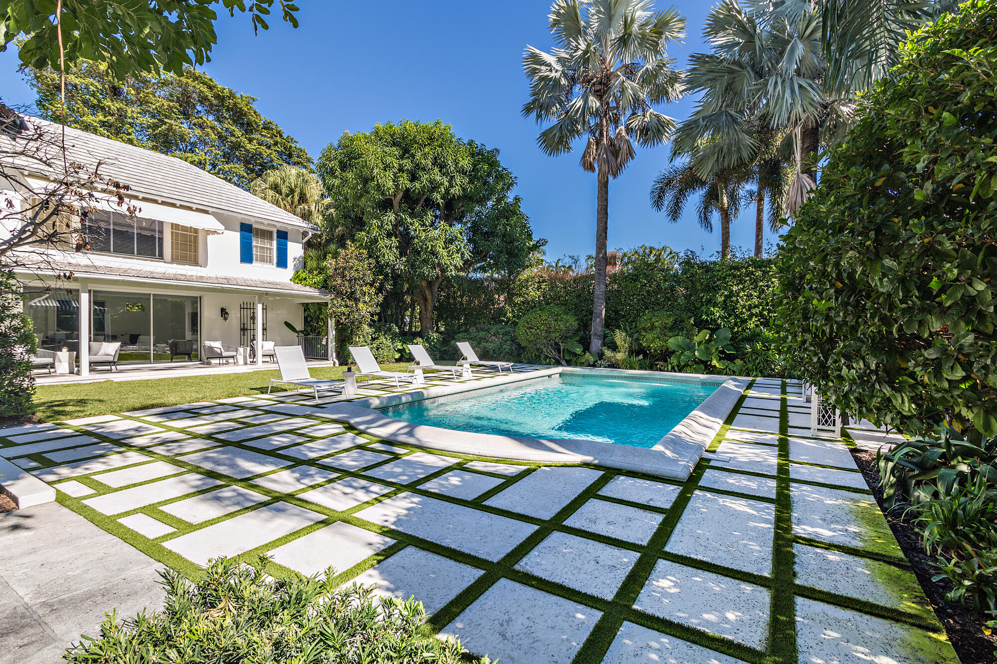 239 Emerald Lane Palm Beach, FL 33480 - Photo 13 of 29 a view of a swimming pool with a lounge chairs