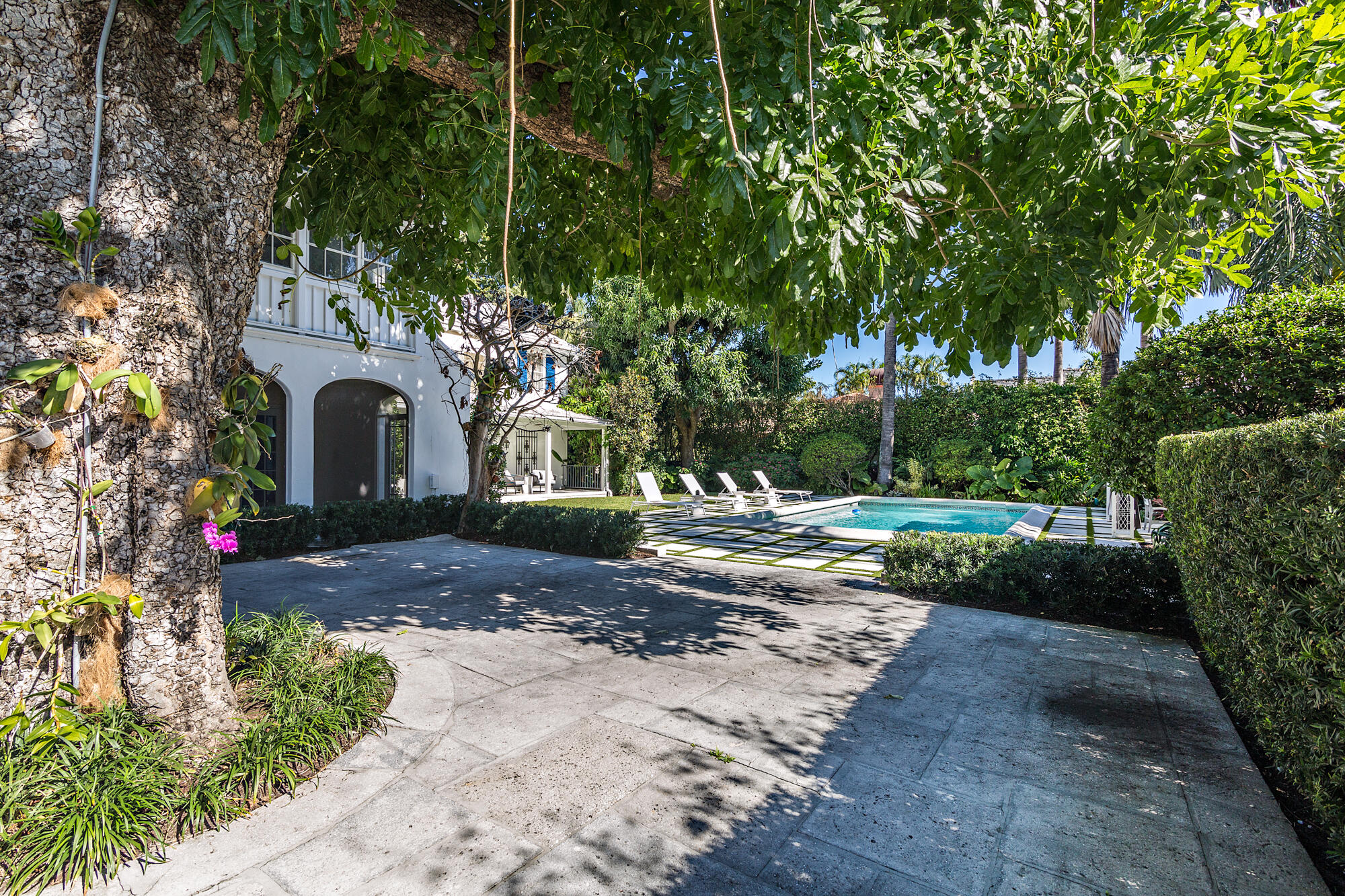 239 Emerald Lane Palm Beach, FL 33480 - Photo 15 of 29 a front view of a house with a yard and garden