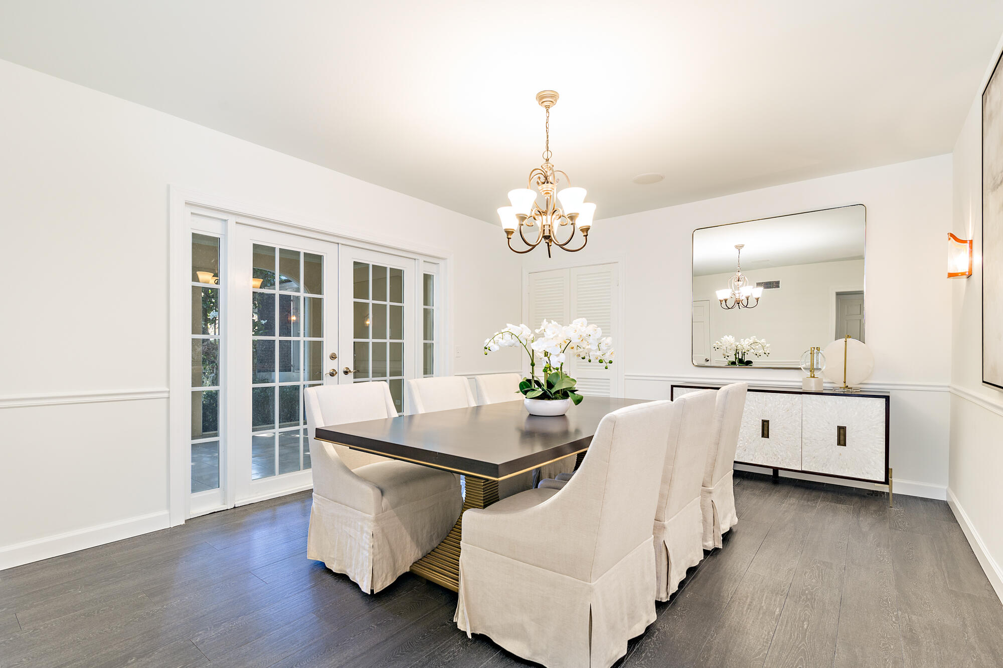 239 Emerald Lane Palm Beach, FL 33480 - Photo 22 of 29 a room with chandelier and wooden floors