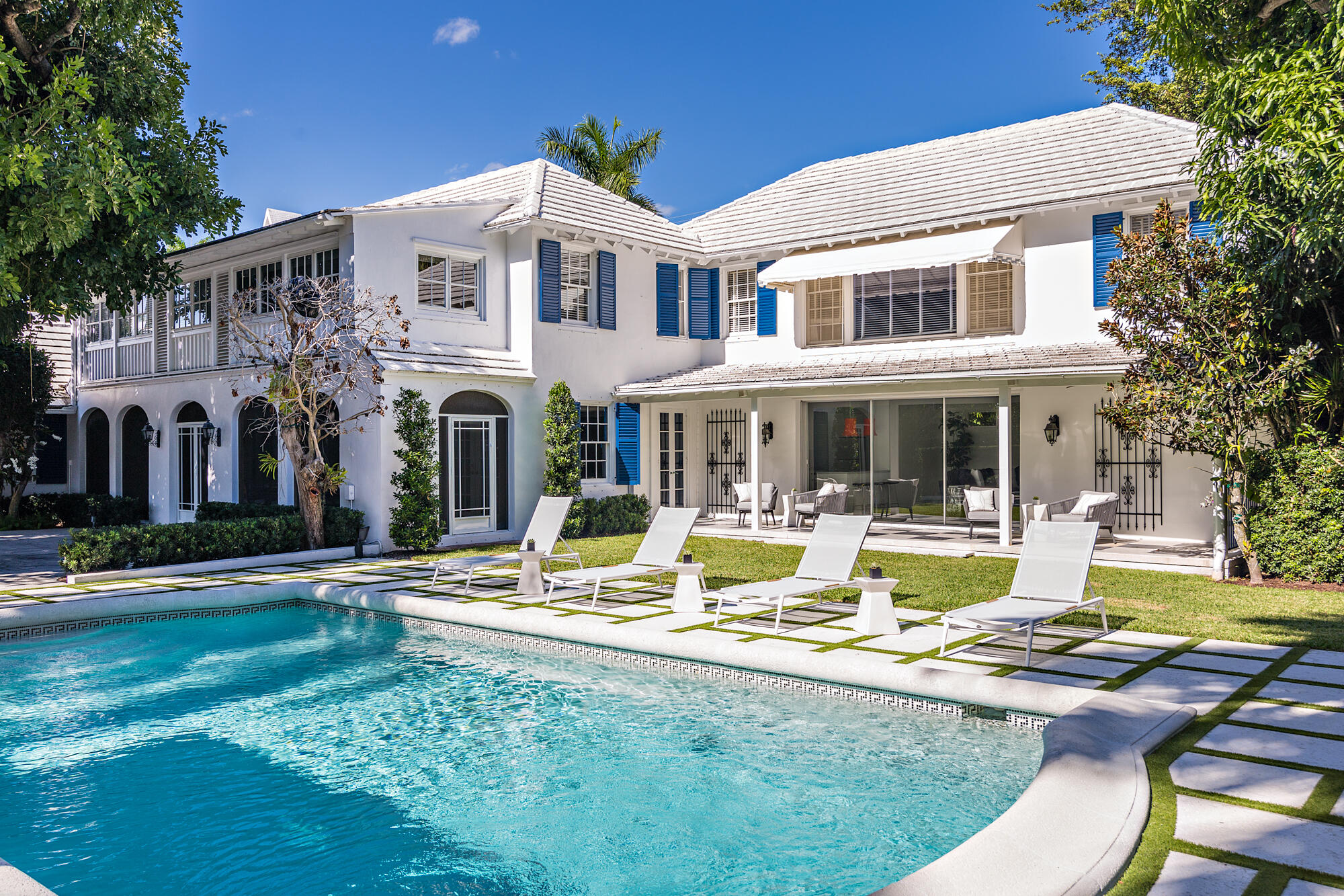 a view of a house with swimming pool and sitting area