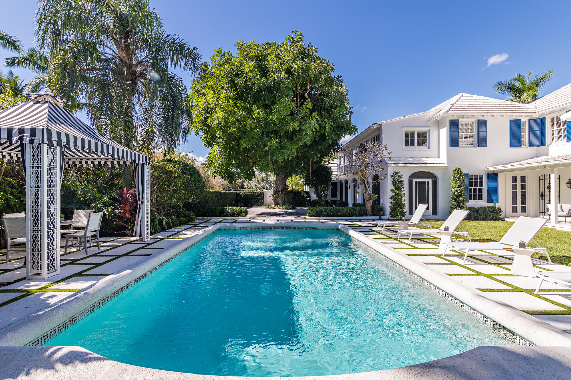 239 Emerald Lane Palm Beach, FL 33480 - Photo 2 of 29 a view of swimming pool with lawn chairs and plants