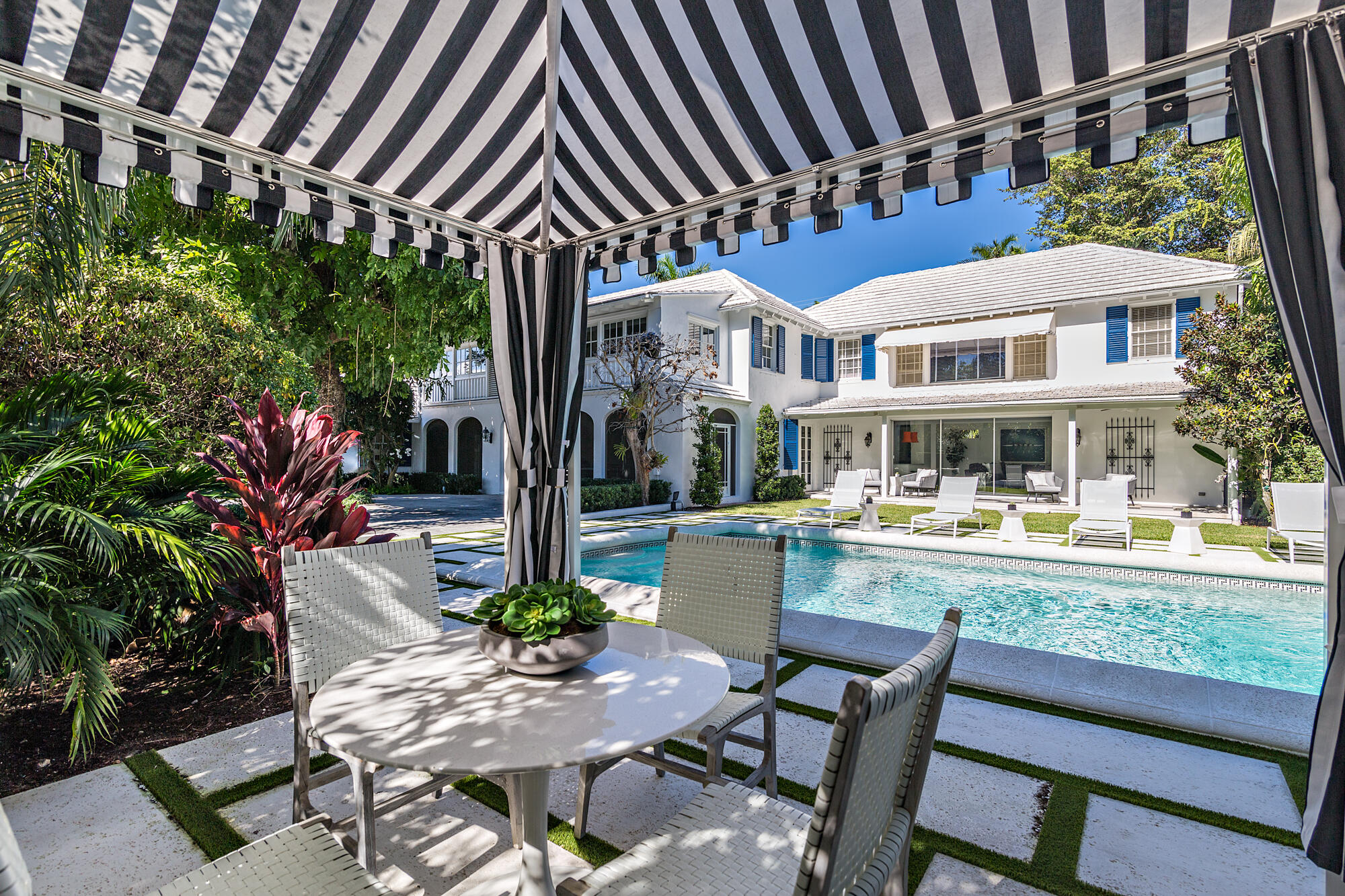 239 Emerald Lane Palm Beach, FL 33480 - Photo 3 of 29 a view of an chairs and table in the patio in front of a house