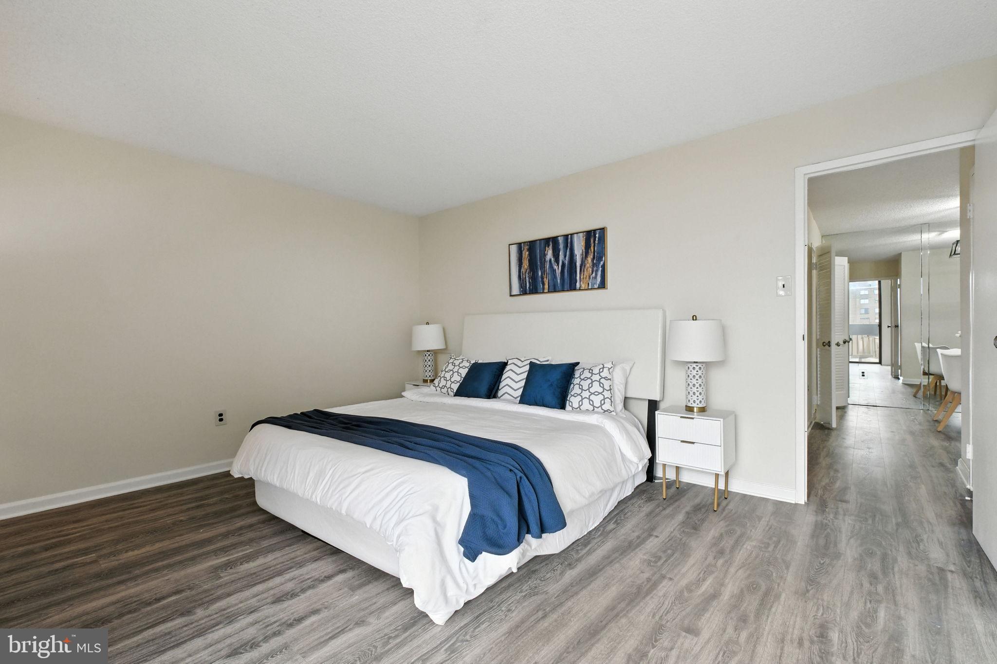 5300 Holmes Run Parkway, Unit 1210 Alexandria, VA 22304 - Photo 12 of 33 a bedroom with a bed and wooden floor