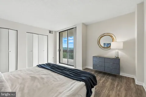 a bedroom with a bed and a dresser