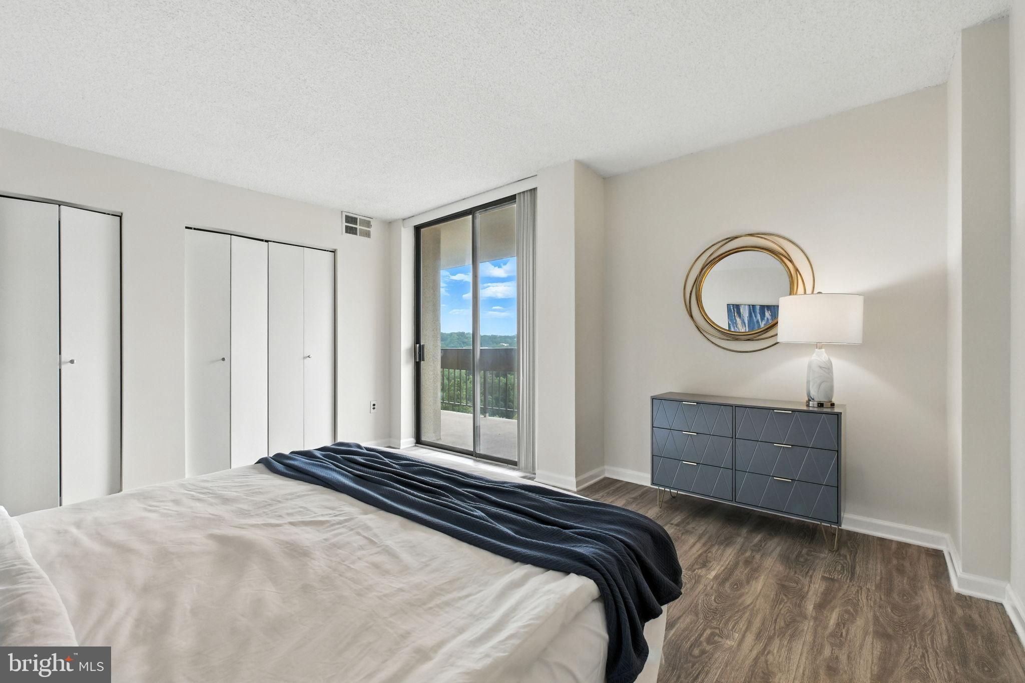 5300 Holmes Run Parkway, Unit 1210 Alexandria, VA 22304 - Photo 14 of 33 a bedroom with a bed and a dresser