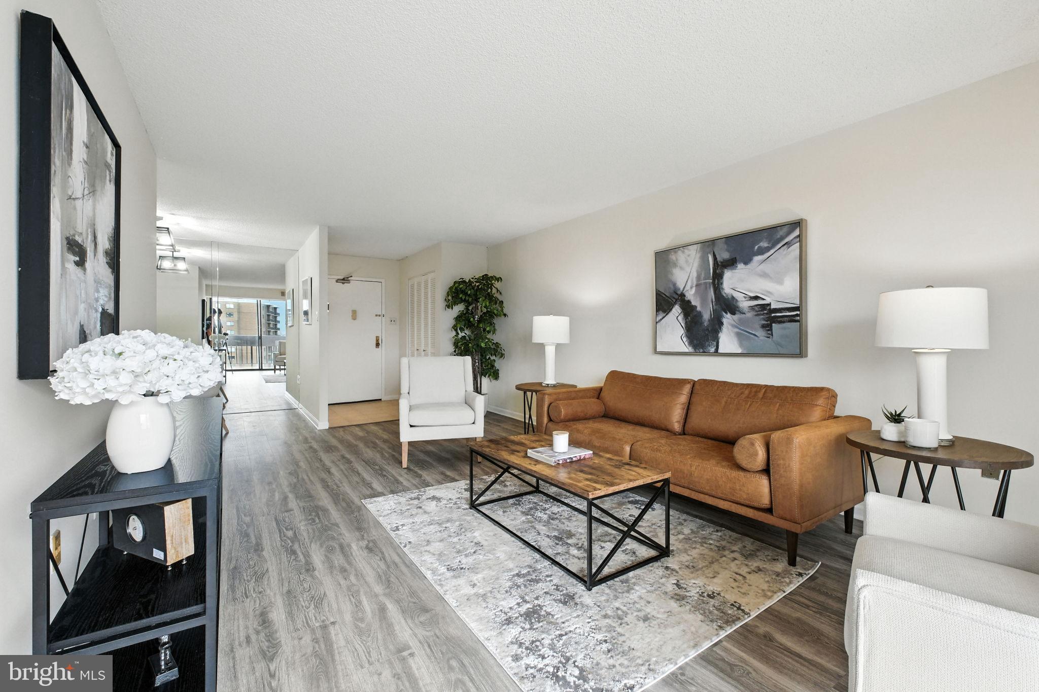 5300 Holmes Run Parkway, Unit 1210 Alexandria, VA 22304 - Photo 2 of 33 a living room with furniture a lamp and a table