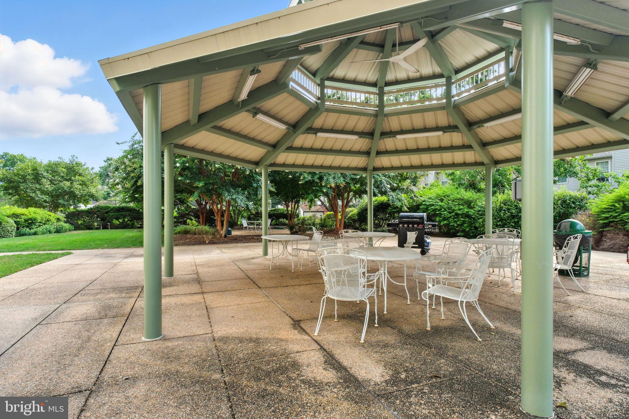 5300 Holmes Run Parkway, Unit 1210 Alexandria, VA 22304 - Photo 24 of 33 a view of a patio with a table and chairs under an umbrella