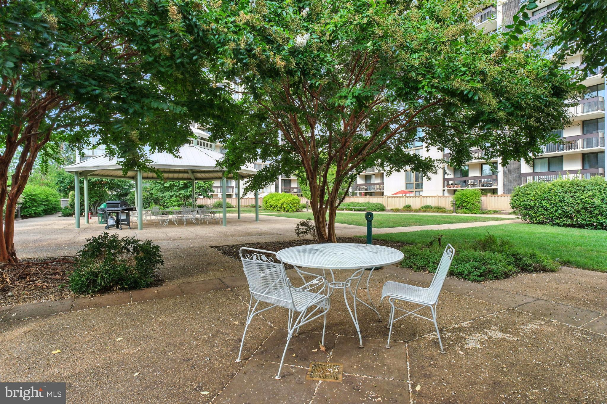5300 Holmes Run Parkway, Unit 1210 Alexandria, VA 22304 - Photo 25 of 33 a view of a tables and chairs in a yard