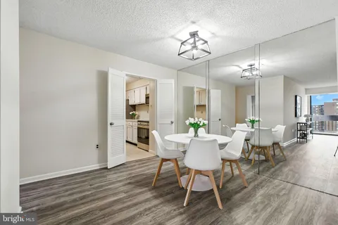 a view of a dining room with furniture and wooden floor