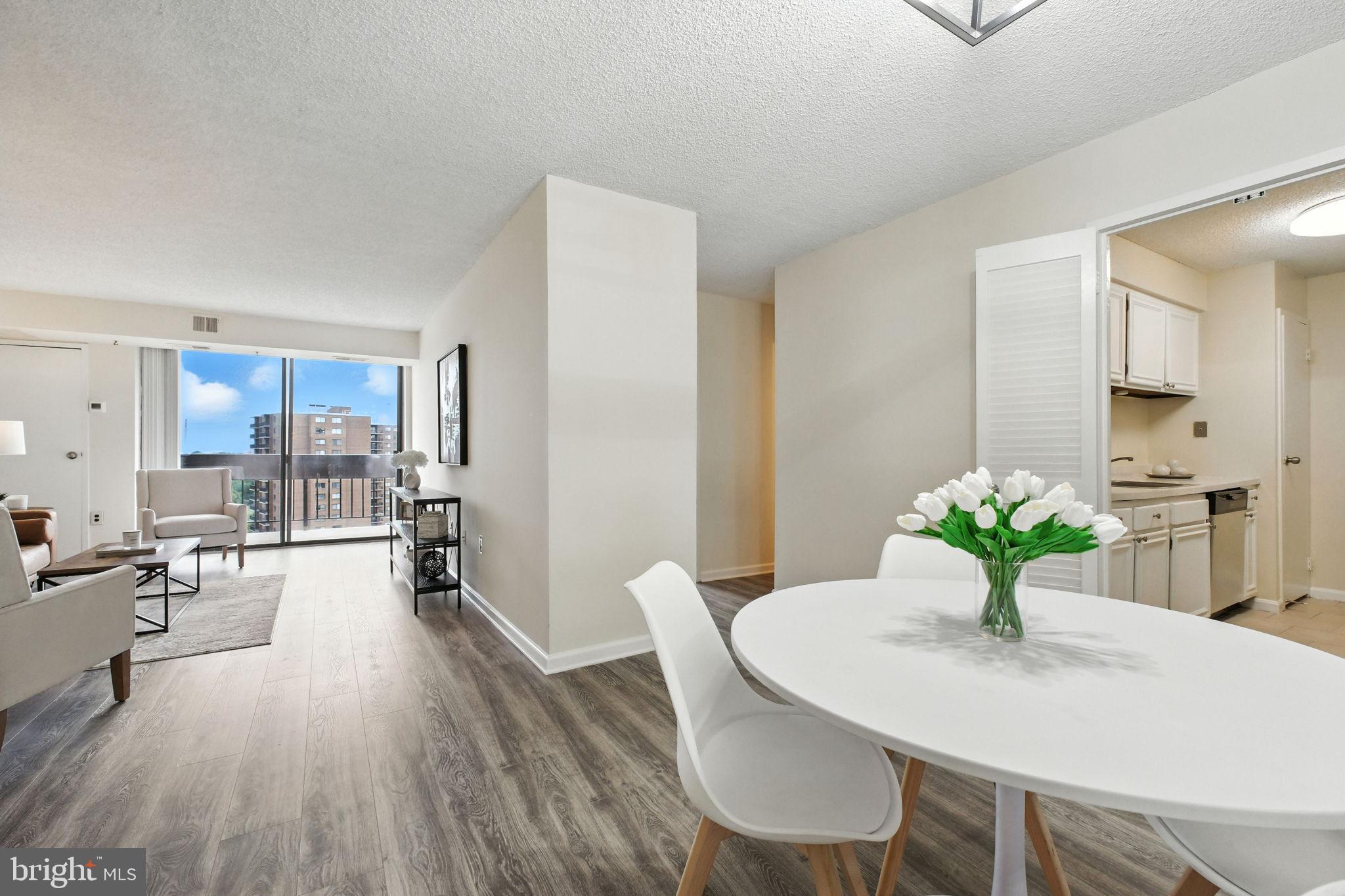 5300 Holmes Run Parkway, Unit 1210 Alexandria, VA 22304 - Photo 6 of 33 a view of a dining room with furniture wooden floor and a chandelier