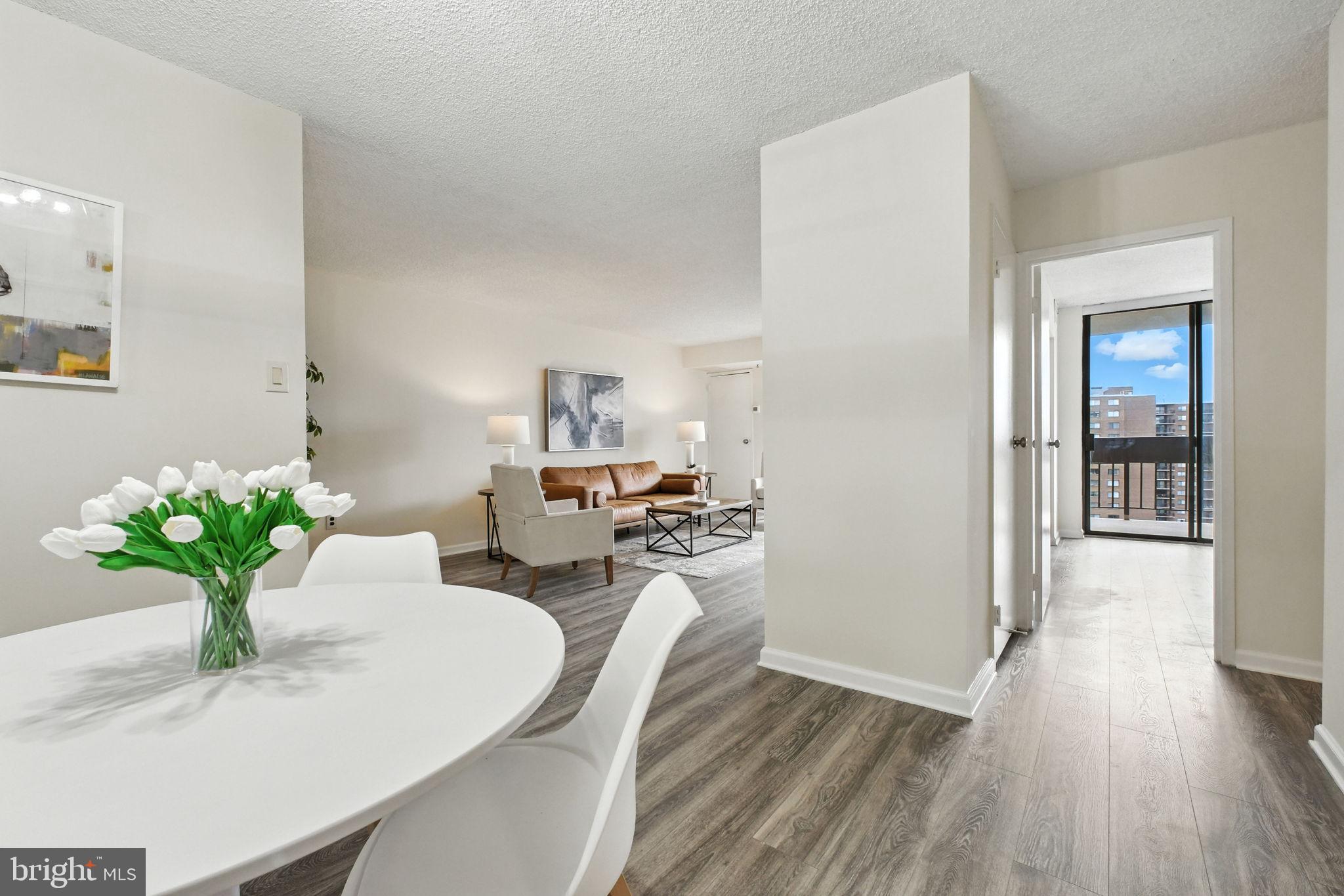 5300 Holmes Run Parkway, Unit 1210 Alexandria, VA 22304 - Photo 7 of 33 a dining room with furniture potted plants and wooden floor