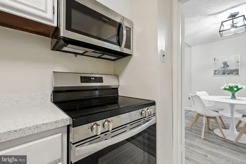 a kitchen with a stove and a microwave