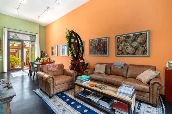a living room with furniture and a book shelf