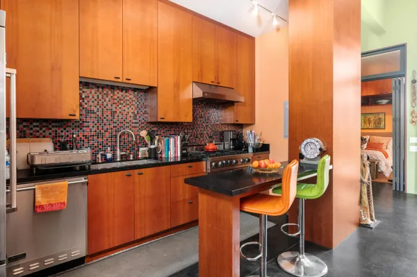 a kitchen with stainless steel appliances granite countertop a sink and cabinets