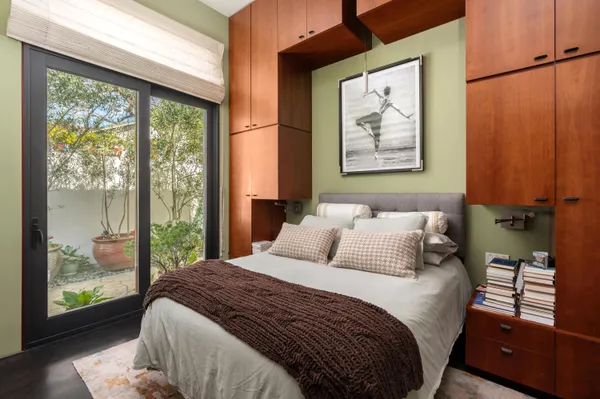 a bedroom with a large bed and a window