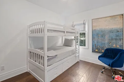 a bedroom with furniture and a window