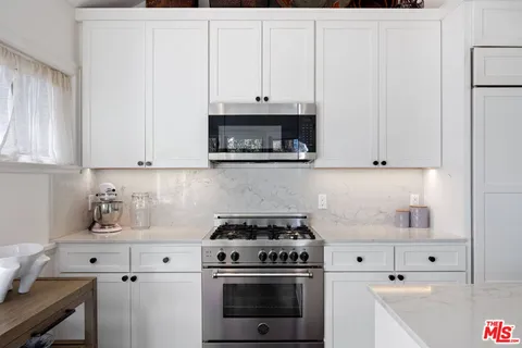 a kitchen with cabinets and appliances